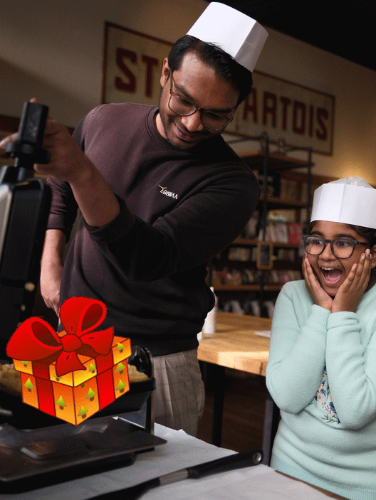 father giving a waffle making voucher to her daughter, surprise!